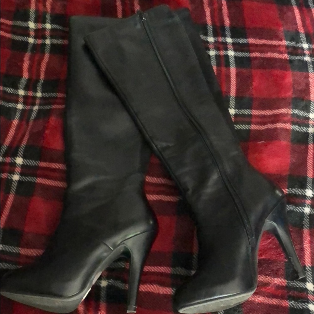 Knee high black high heeled boots